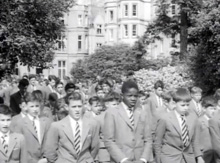 A group of schoolboys walking down the President Hall approach.