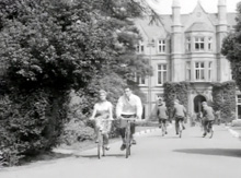 Cycling in front of President Hall.