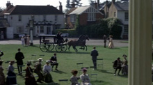 A hearse crosses Englefield Green in front of the Barley Mow pub.